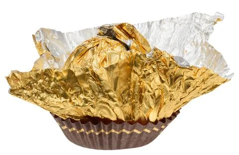 Empty golden foil wrapper from round candy, partially unfolded and placed i.. Stock Photos