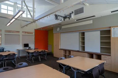 Empty grade school classroom with Apple Mac computer and empty whiteboard Stock Photos