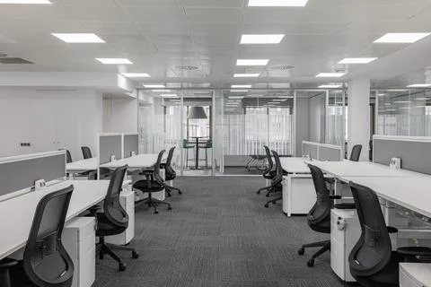 Empty gray office with tables and chairs after the bankruptcy of a large travel Stock Photos