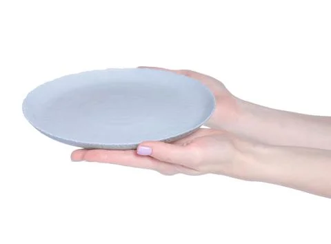 Empty gray plate in hand Stock Photos