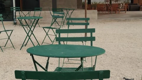 Empty Green Bistro Chairs and Table on a Gravel Café Patio Stock Footage 339127245