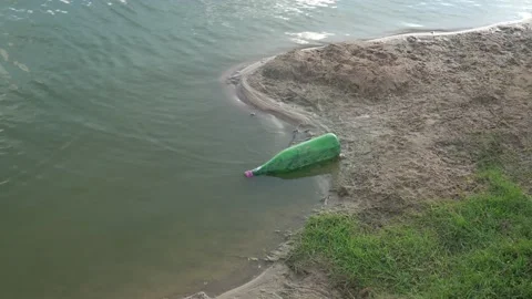 Empty green bottle floating Empty green bottle floating - Water pollution Stock Footage 156277563