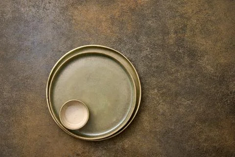 Empty green ceramic two plates and saucepan one in one on rustic background Stock Photos