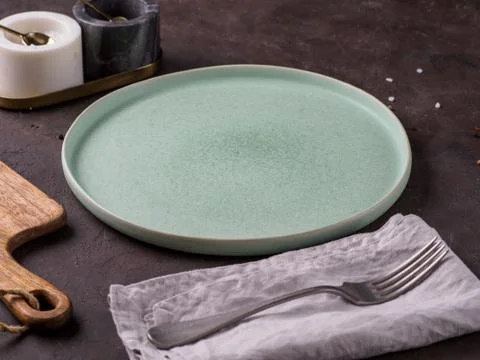 Empty green plate on dark background. Stock Photos