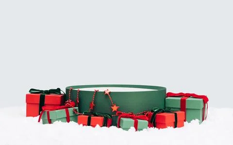 Empty green round gift box in the snow isolated on blue background.  Stock Photos