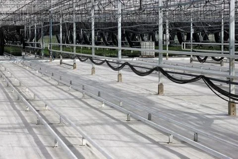 Empty greenhouse with a drip irrigation system in the nursery of  plants. Stock Photos
