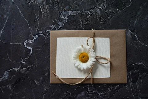 An empty greeting card with a brown envelope and a white flower for mom on a  Stock Photos