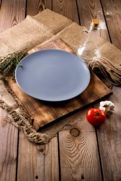 Empty grey plate, rustic dark background Stock Photos
