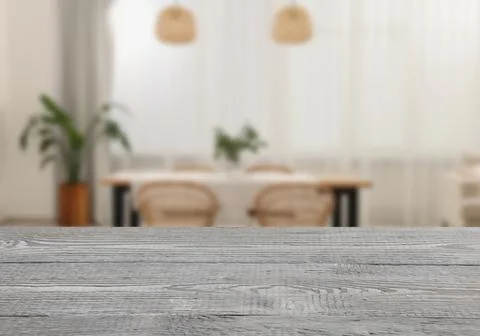 Empty grey wooden table in dining room. Space for design Stock Photos