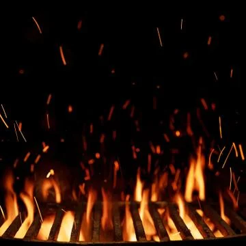 Empty grill grid with fire isolated on black background Stock Photos