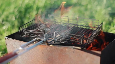 Empty grill over open fire. Summer picnic barbecue cooking on the grill Stock Footage 46304964