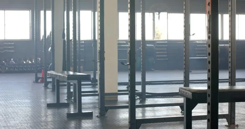 Empty gym with weightlifting equipment and benches Stock Footage 299227135