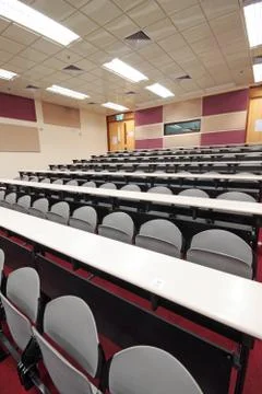 Empty hall for presentation with grey armchairs Stock Photos