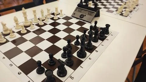 An empty hall with tables on which chess boards and timers are prepared. Co.. Stock Photos