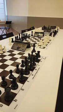 An empty hall with tables on which chess boards and timers are prepared. Co.. Stock Photos