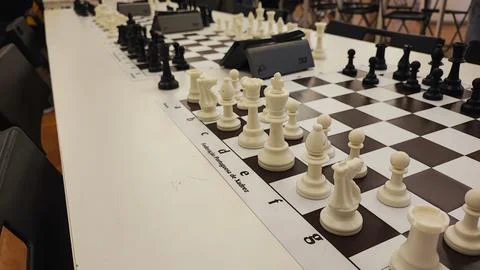 An empty hall with tables on which chess boards and timers are prepared. Co.. Stock Photos