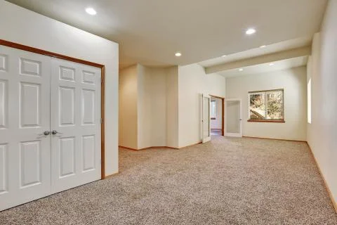 Empty hallway interior with carpet floor and creamy walls. Stock Photos