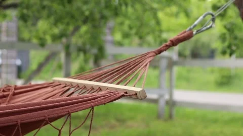 Empty hammock on blurred nature background Stock Footage 309880778