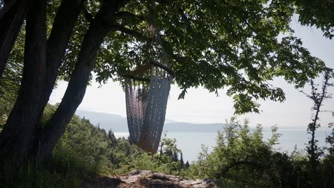 Empty hammock hanging on tree. Cozy place for relax, scenic view on Lake Garda 스톡 동영상 127544206