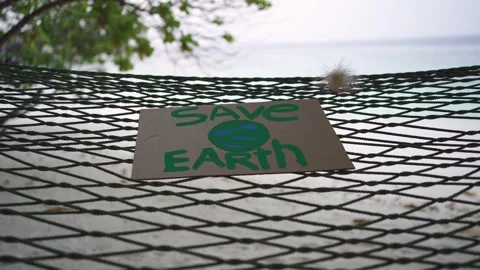 An empty hammock with a "Save the Earth" Stock Footage 146651800