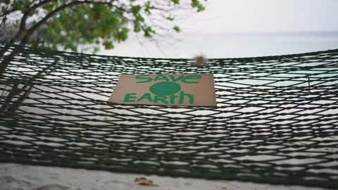 An empty hammock with a "Save the Earth" Stock Footage 146651835
