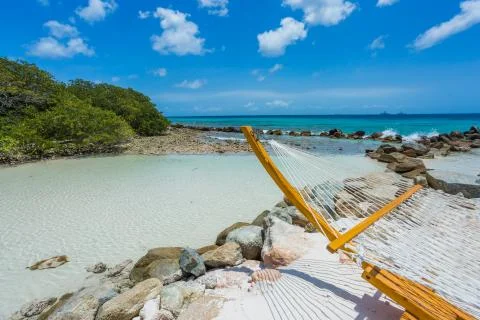 Empty hammock on tropical beach Stock Photos