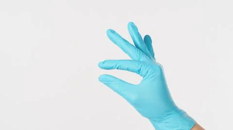 Empty hand and finger do holding gesture and wear blue latex glove on white b Stock Photos