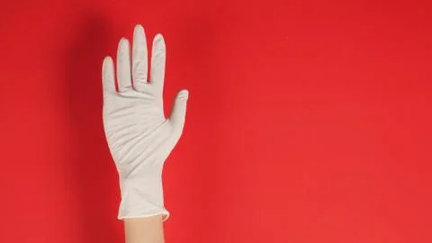 Empty hand  with gloves in right hand on red background. Stock Photos