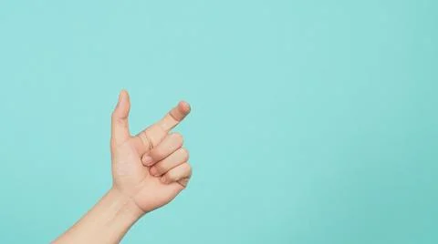 Empty Hand holding or catch nothing guesture on green and blue or mint backgr Stock Photos