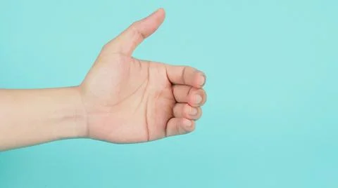 Empty Hand holding or catching guesture on green mint background. Stock Photos