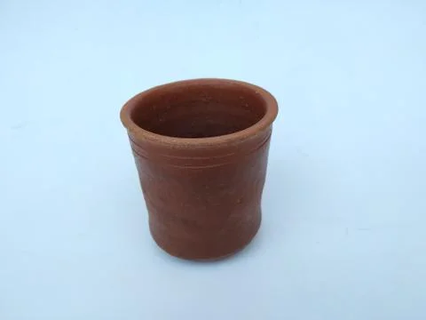 Empty Hand Made Sand or Clay Red Glass isolated on White Background Stock Photos
