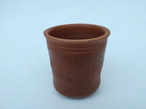Empty Hand Made Sand or Clay Red Glass isolated on White Background 스톡 사진