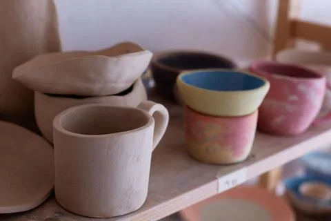 Empty handmade tableware. ceramic cups on the shelf. Handmade work Stock Photos