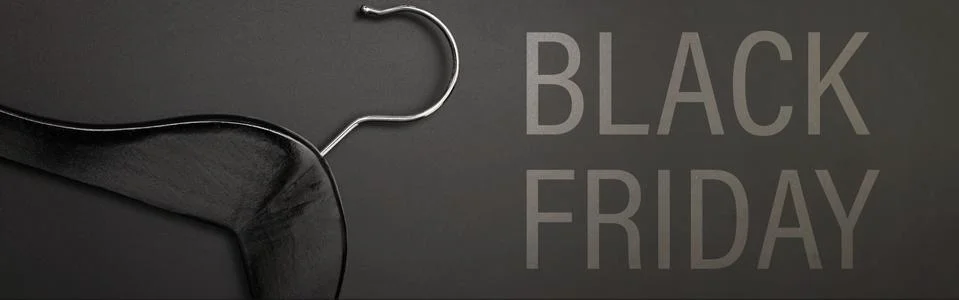 Empty hanger for clothes on black background Stock Photos