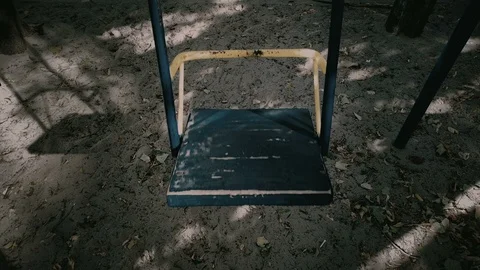 Empty hanging swing in outdoors yard, sad childhood memories, creepy horror Stock-Footage 119033347