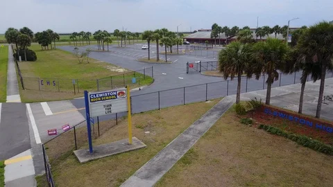 Empty High School Campus Due to Coronavirus aerial Sign to Parking Stock Footage 128673594