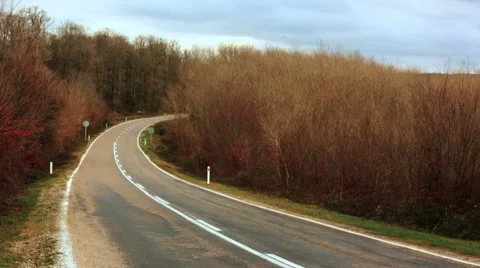 Empty highway among beautiful autum trees and the cars passing rarely Stock Footage 58496775