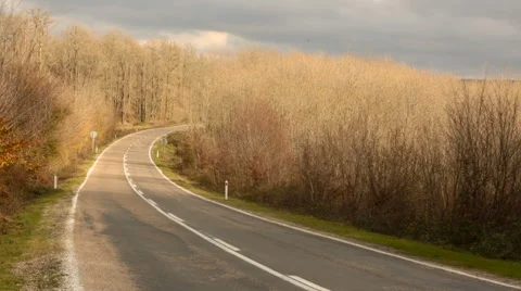 Empty highway among beautiful autum trees and the  cars passing rarely Video stock 58496802