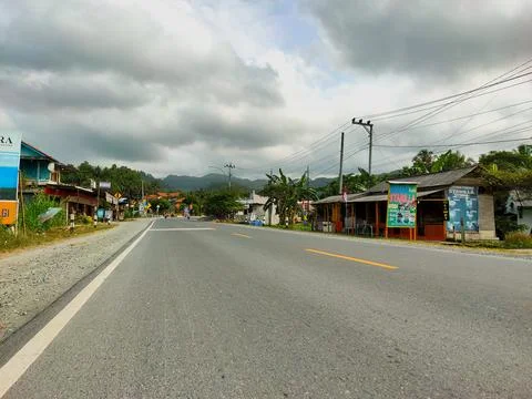 Empty highway and cloudy skies Stock Photos