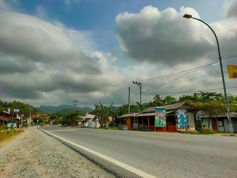 Empty highway and cloudy skies Stock Photos