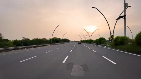 Empty highway road leading to Taj Mahal in Agra India at sunset Stock Footage 346580821