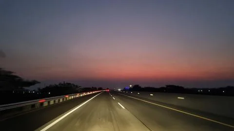 Empty highway road at sunset with light trails. Stock-Fotos