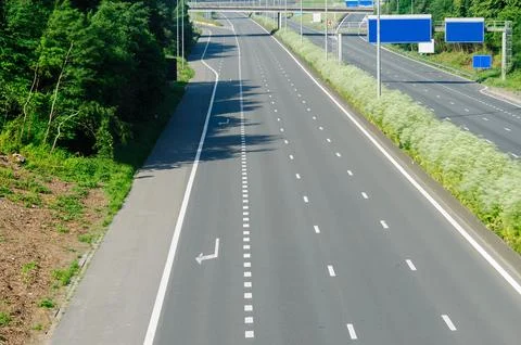 Empty Highway Road Surrounded by Nature and Lush Greenery Stock Photos