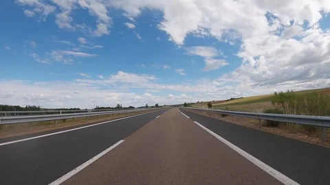 Empty highway road through the fields outside the city during sunny day. Spain Stock Footage 248492284