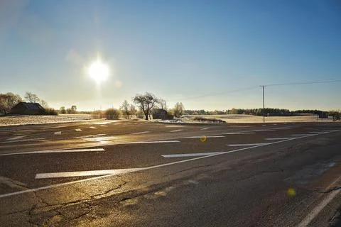 Empty highway with snow fields on both sides with a beautiful day Stock Photos
