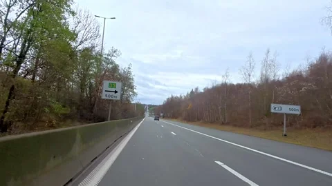 Empty highway surrounded by trees under cloudy sky Video stock 324254356
