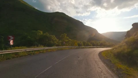 An empty highway through the mountains. On the way to the sun Stock Footage 257126862