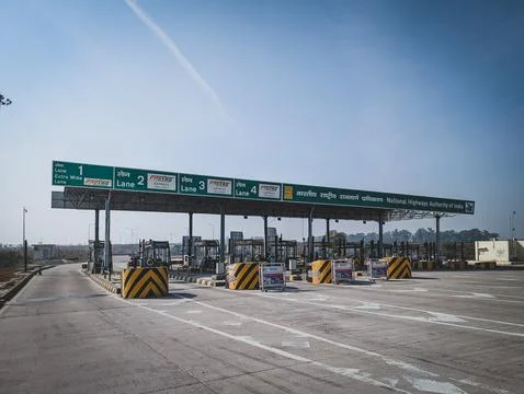 Empty highway toll plaza under clear sky Stock Photos