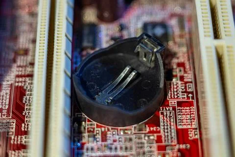 Empty holder for coin cell power supply on computer hardware part with various Stock Photos