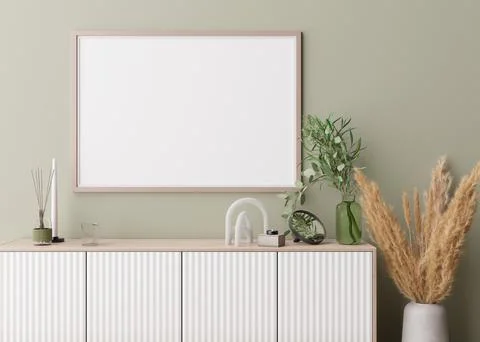 Empty horizontal picture frame on light green wall in modern living room. Moc Stock Photos